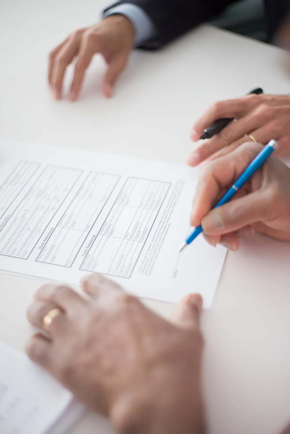The customer signs the printed document with a pen
